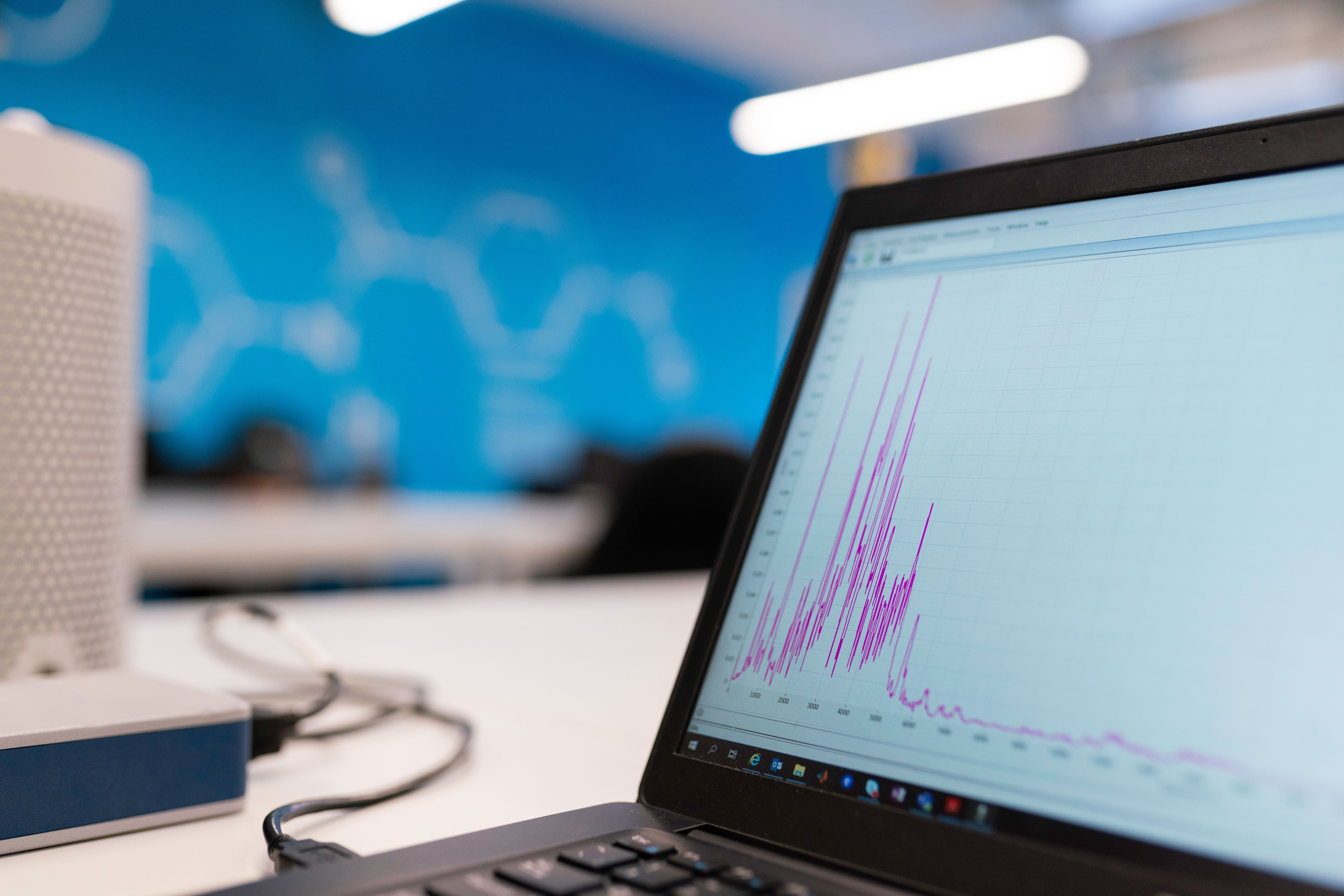 Laptop screen displaying colorful data analytics graph showing business growth metrics