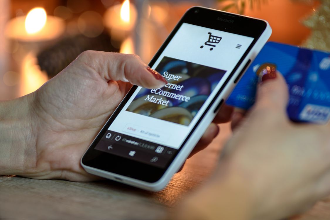 Person shopping on a smartphone with a credit card
