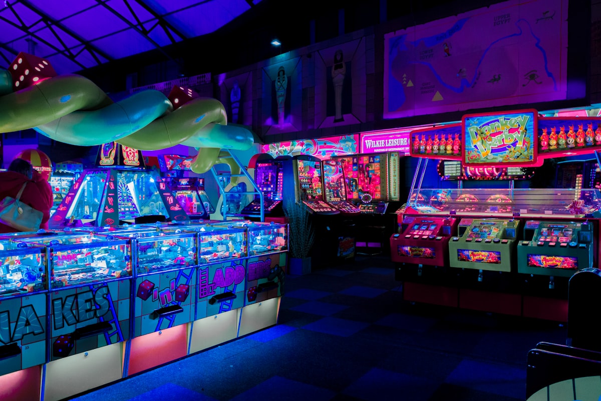 Close-up of a colorful pinball machine playfield with neon lighting and chrome details