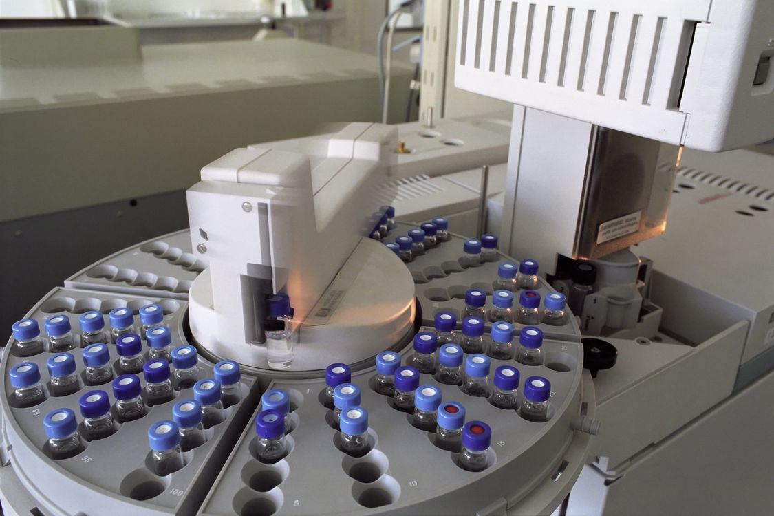 Laboratory chromatograph with multiple glass vials used for analytical purity testing