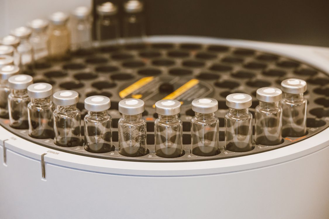 Clear glass vials arranged in a laboratory container representing tested peptide products