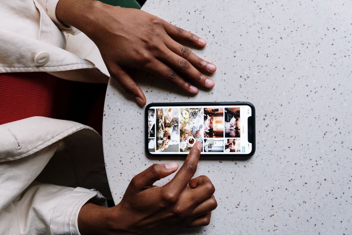 Malawi Breaking News: How MFN Verifies Updates 24/7 4 A reader following news on a smartphone at a table