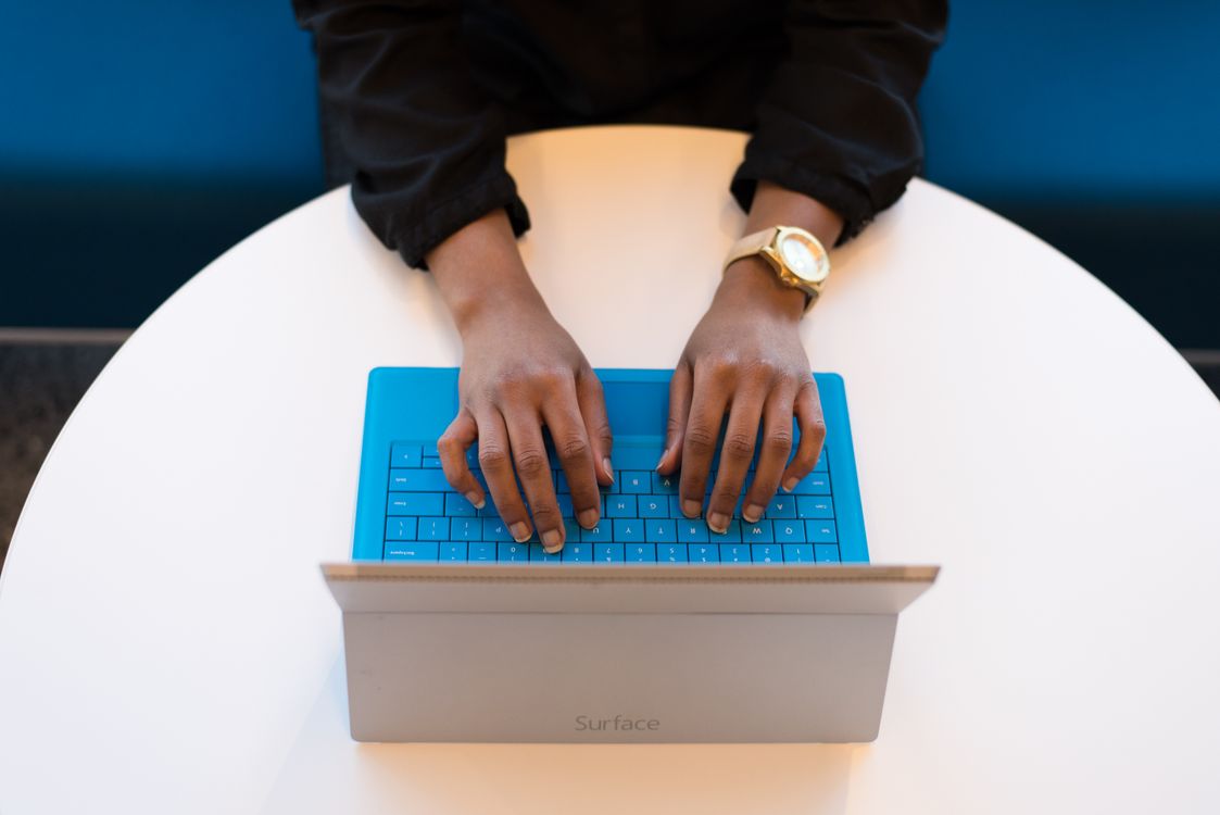 Malawi Breaking News: How MFN Verifies Updates 24/7 3 A journalist working at a laptop keyboard in a professional newsroom setting