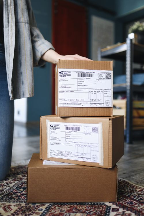 Stacks of cardboard shipping boxes with labels ready for ecommerce fulfillment