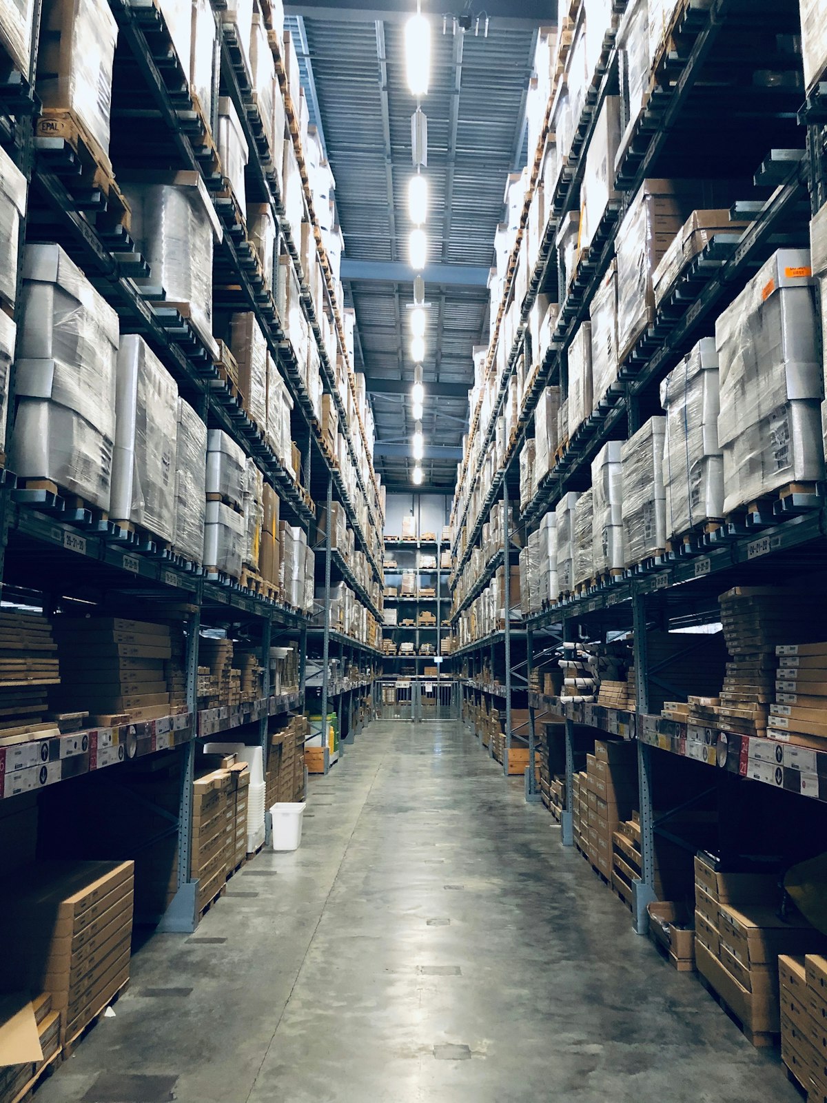 Warehouse interior with organized shelving and cardboard boxes on pallets
