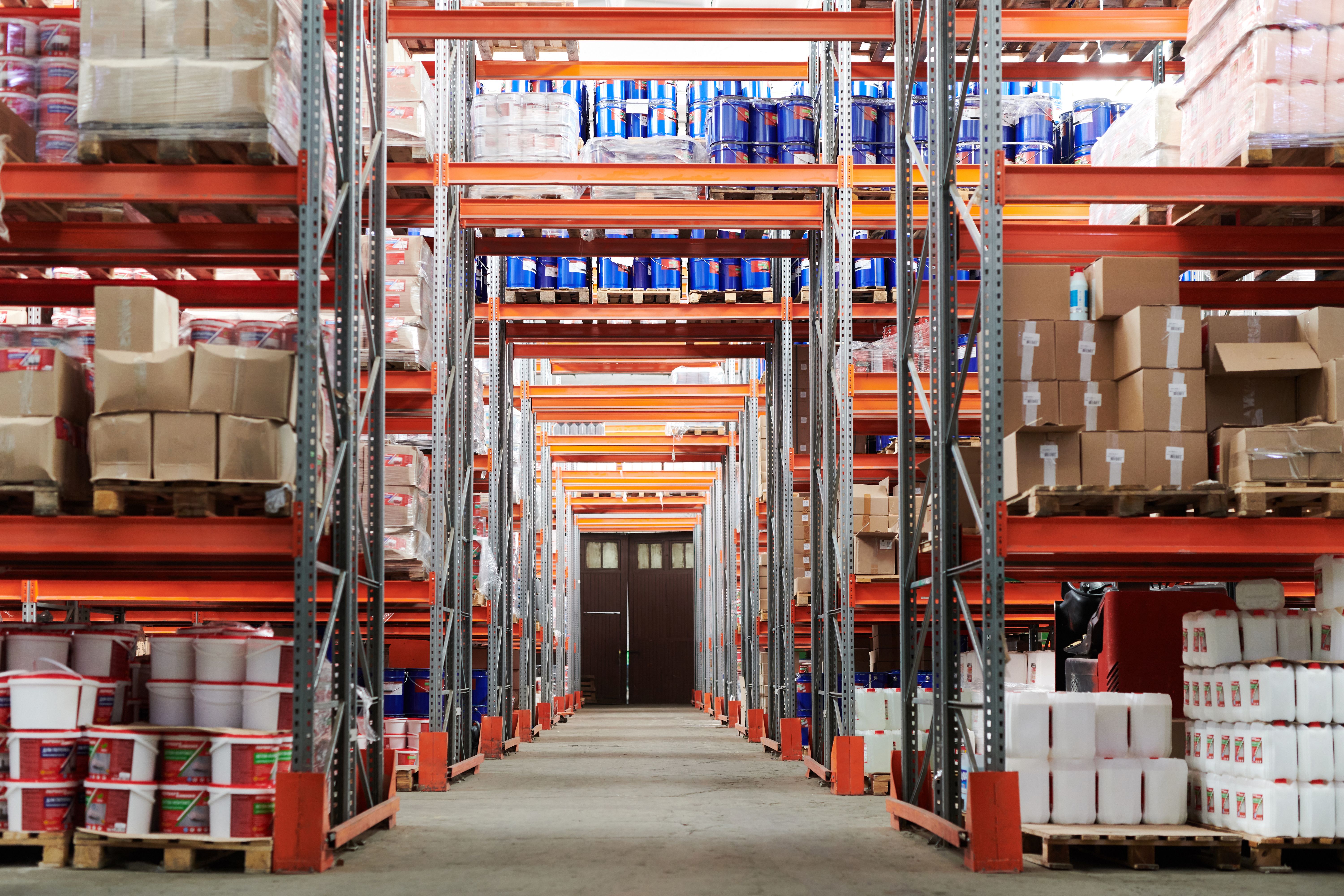 Stacked wooden pallets loaded with boxed merchandise in a warehouse distribution center