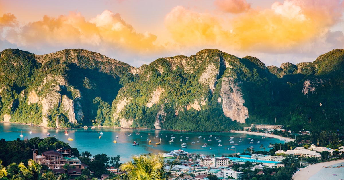 Aerial view of Phi Phi Islands showing emerald green water and white sand beaches surrounded by jungle-covered cliffs