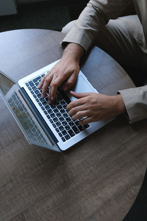 Professional working on a laptop reviewing an inbox dashboard