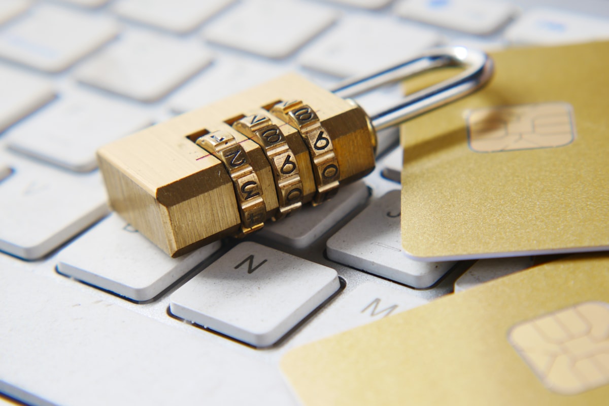 Golden padlock resting on a computer keyboard representing data encryption and security.