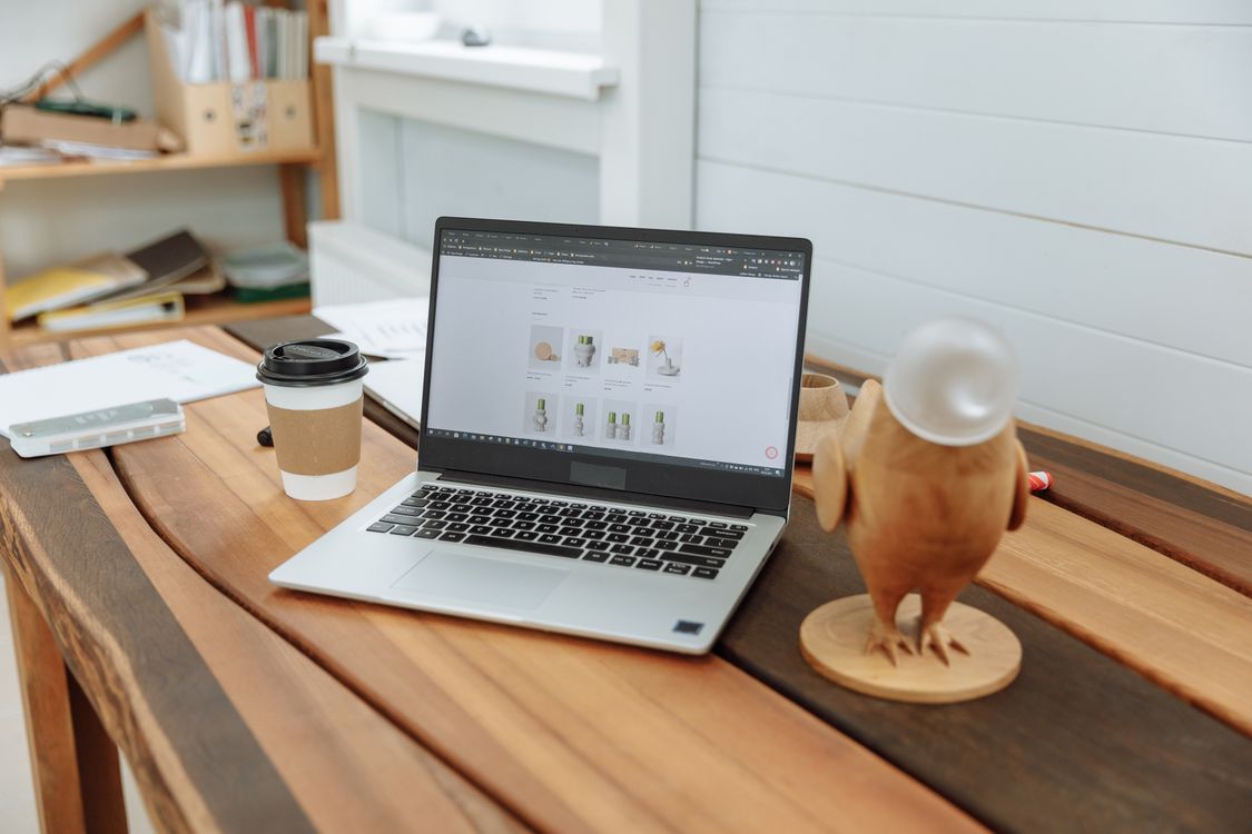 Laptop displaying a business website on a desk in a modern office
