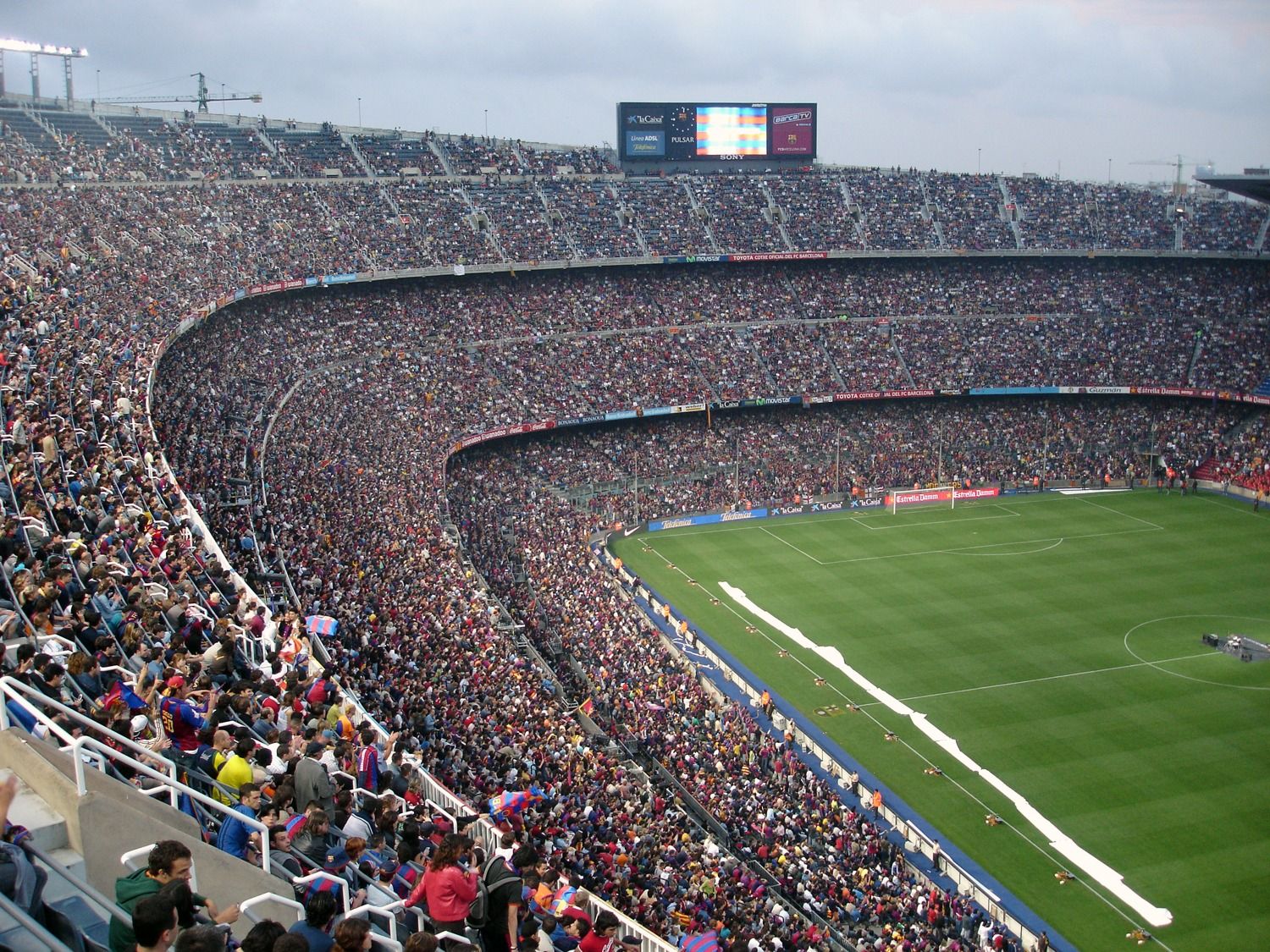 Football stadium during a live match with fans in attendance