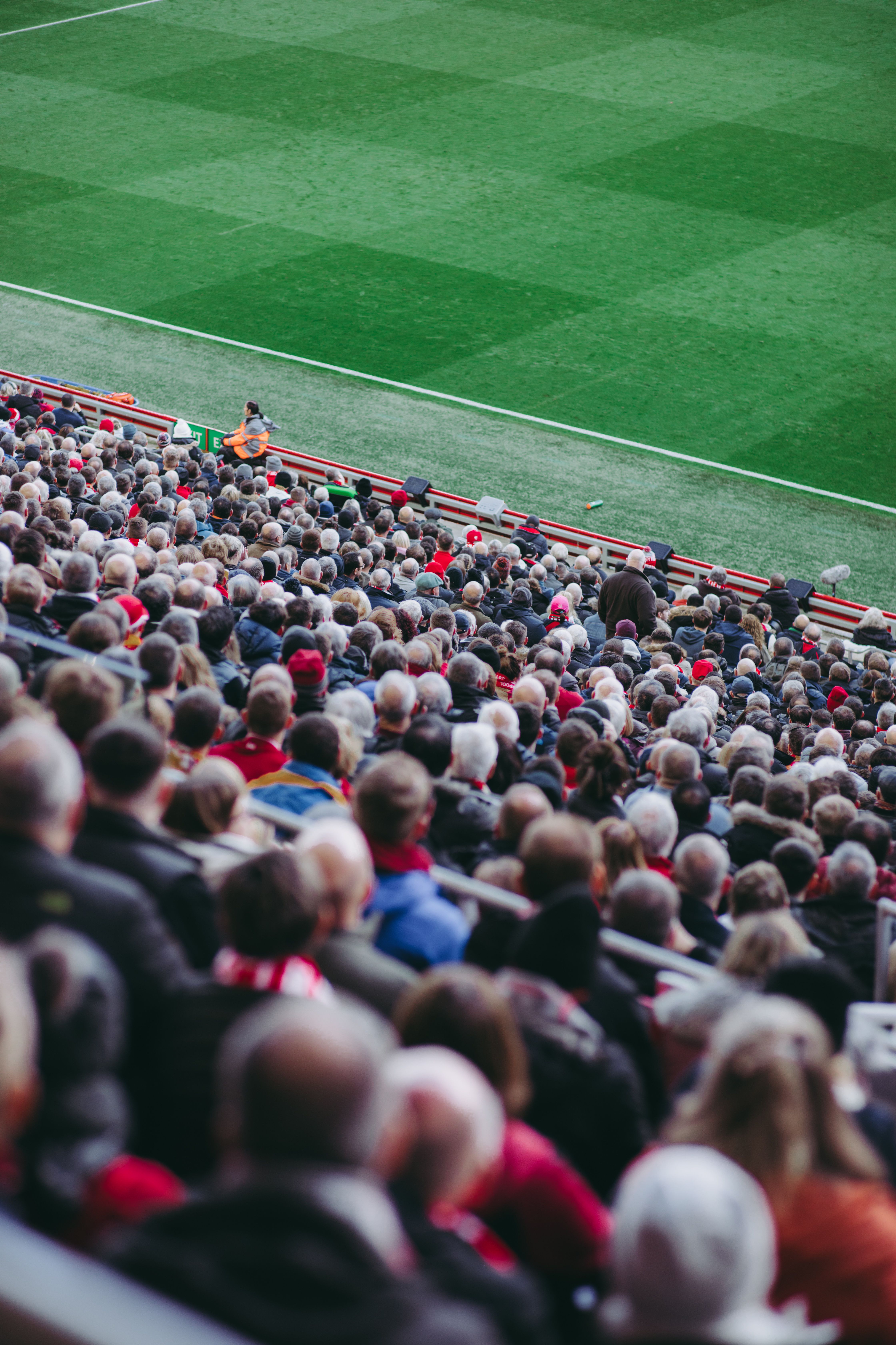 Enthusiastic football fans cheering inside a stadium during a live match