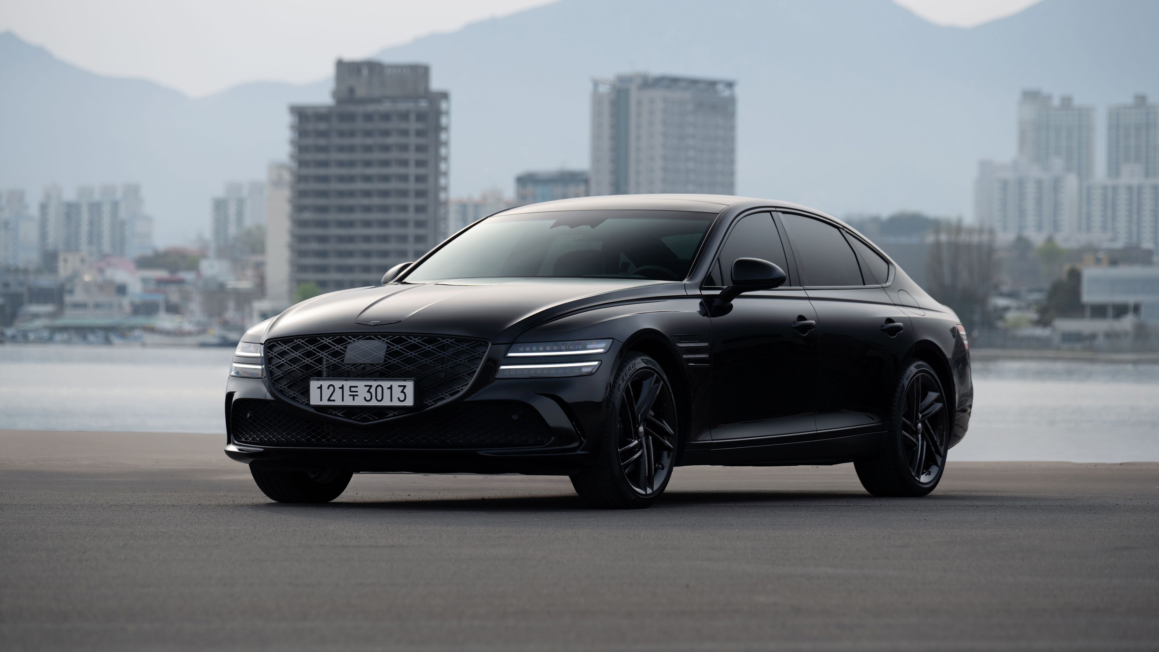Black luxury sedan parked in an urban setting, suited to a chauffeur service