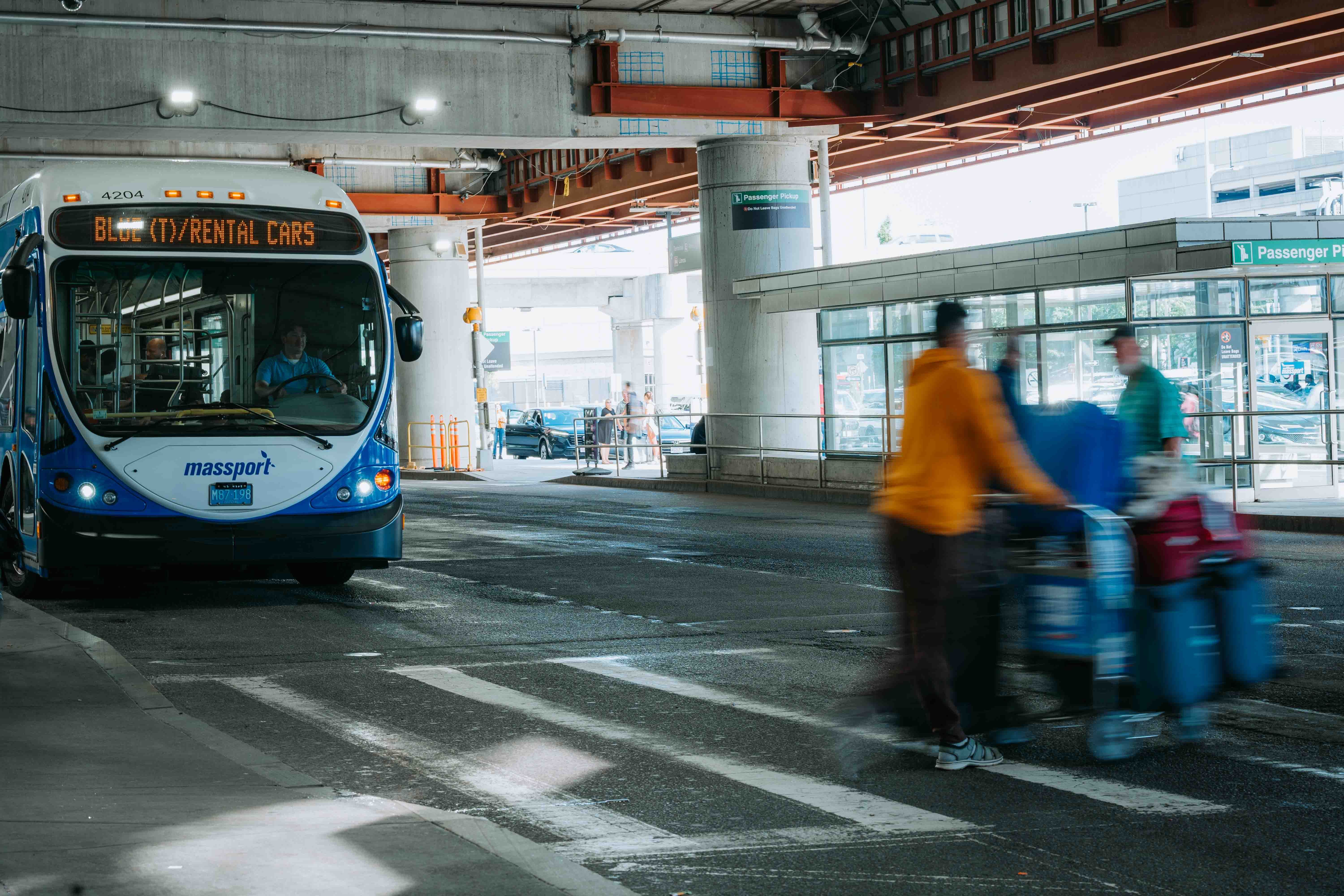 Airport shuttle bus waiting at a terminal pickup area
