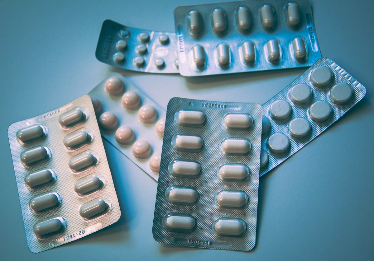 Assorted probiotic supplement capsules and vitamins on a light surface