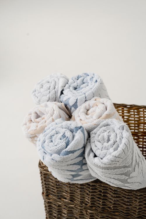 Rolled towels arranged in a wicker basket