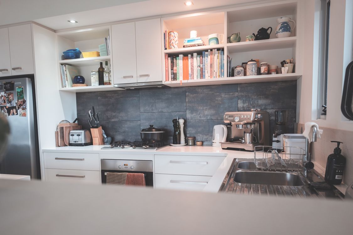 Minimalist small apartment kitchen zone with modern appliances