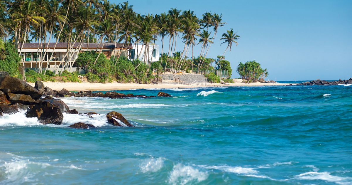 Coastal road and turquoise sea along the Sri Lankan east coast