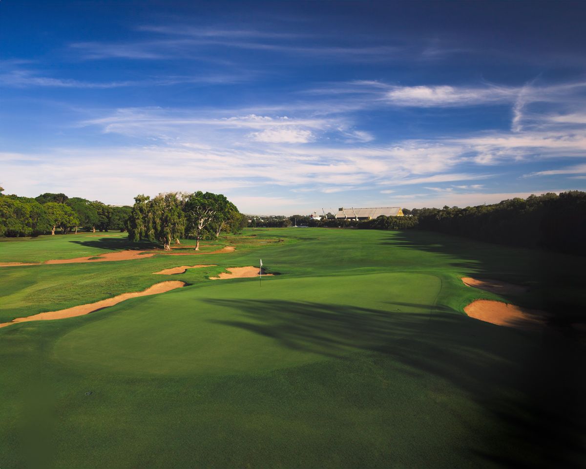 Aerial view of a manicured championship golf course with sand bunkers and green fairways