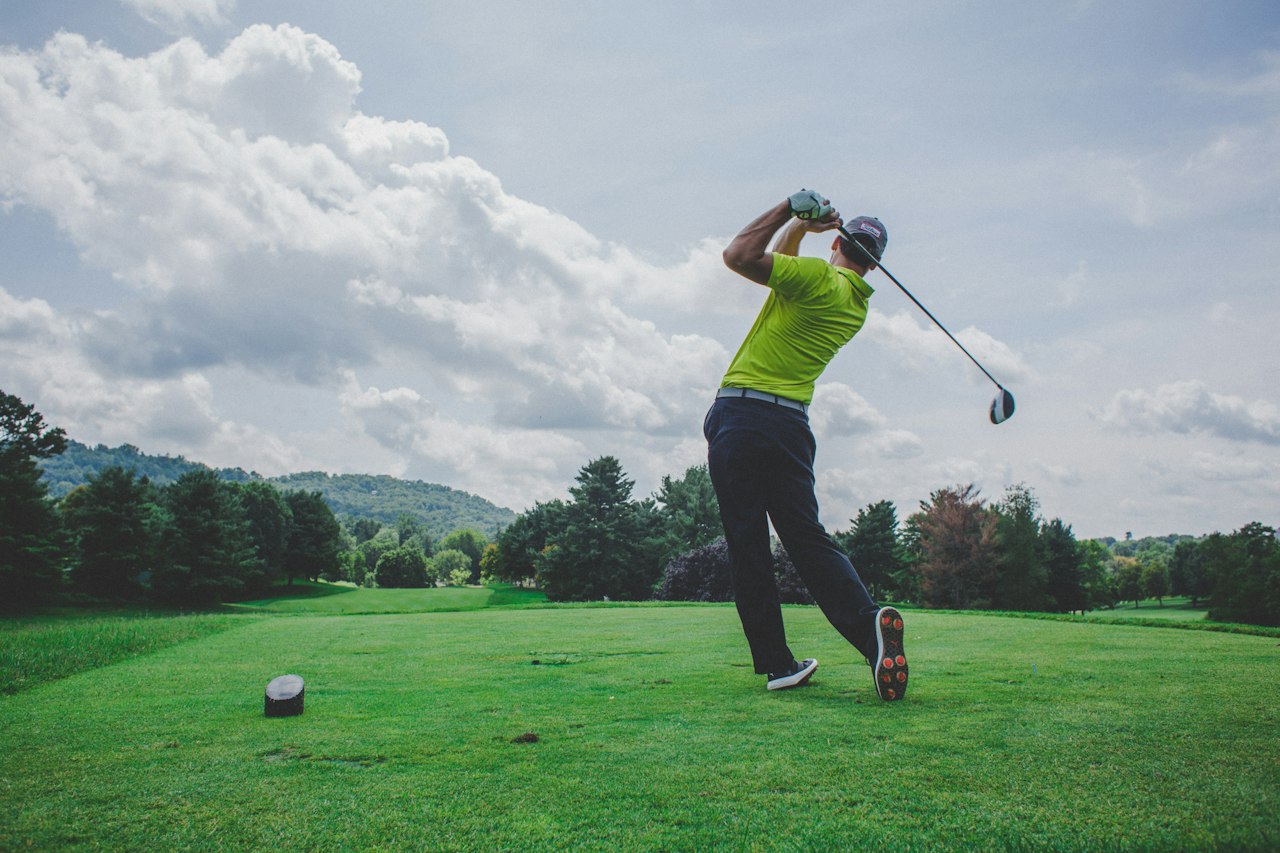 Golfer taking a shot on a lush resort course