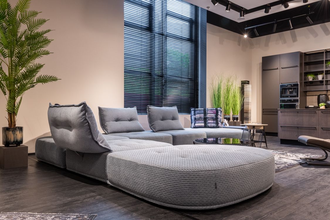 Modern grey sofa in a contemporary living room with natural light