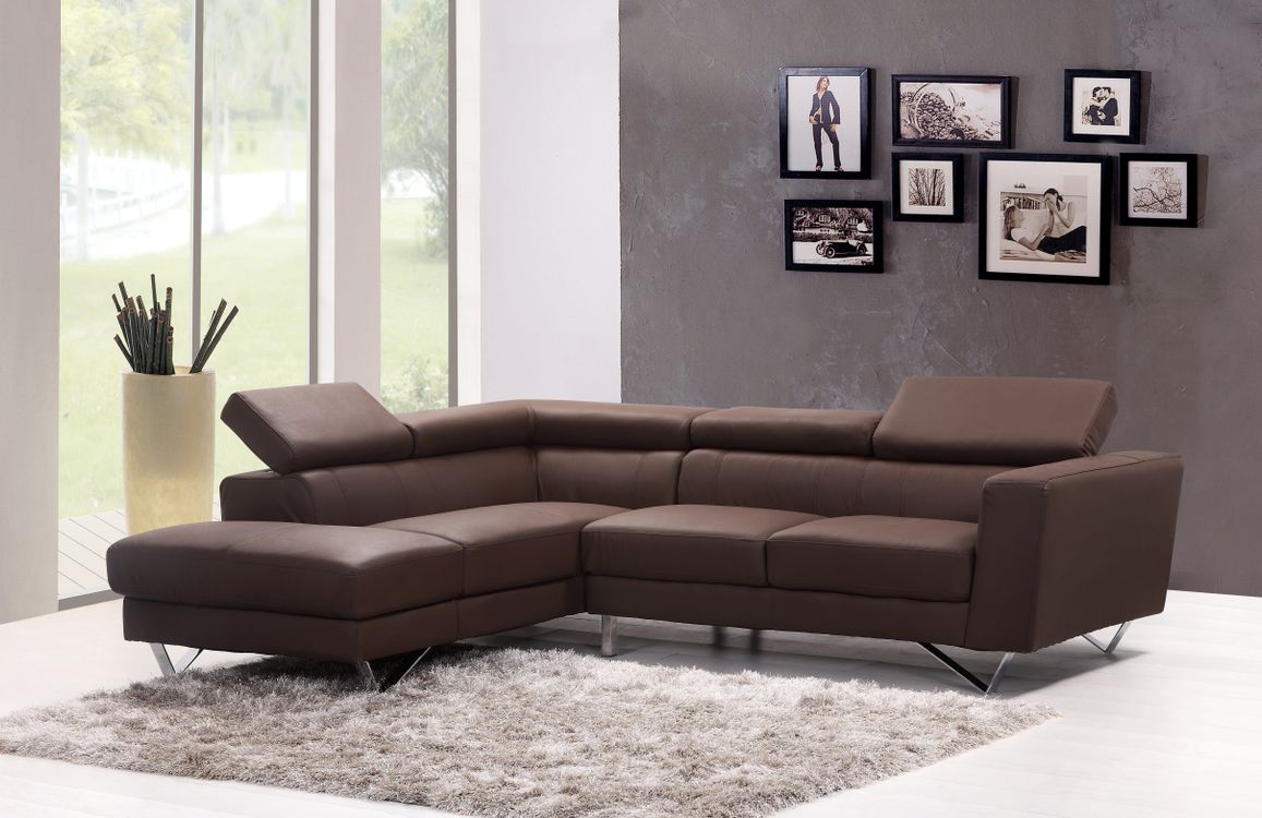 Brown leather sofa in a contemporary living room with framed wall art