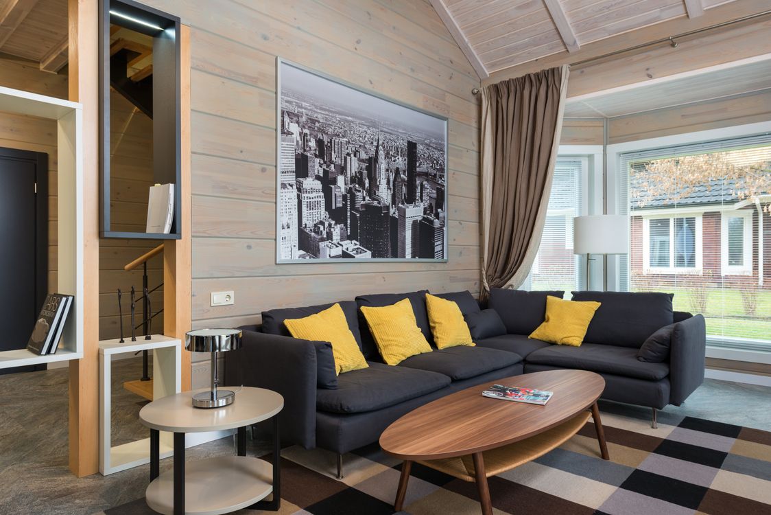 A contemporary grey sectional sofa with accent cushions in a modern living room