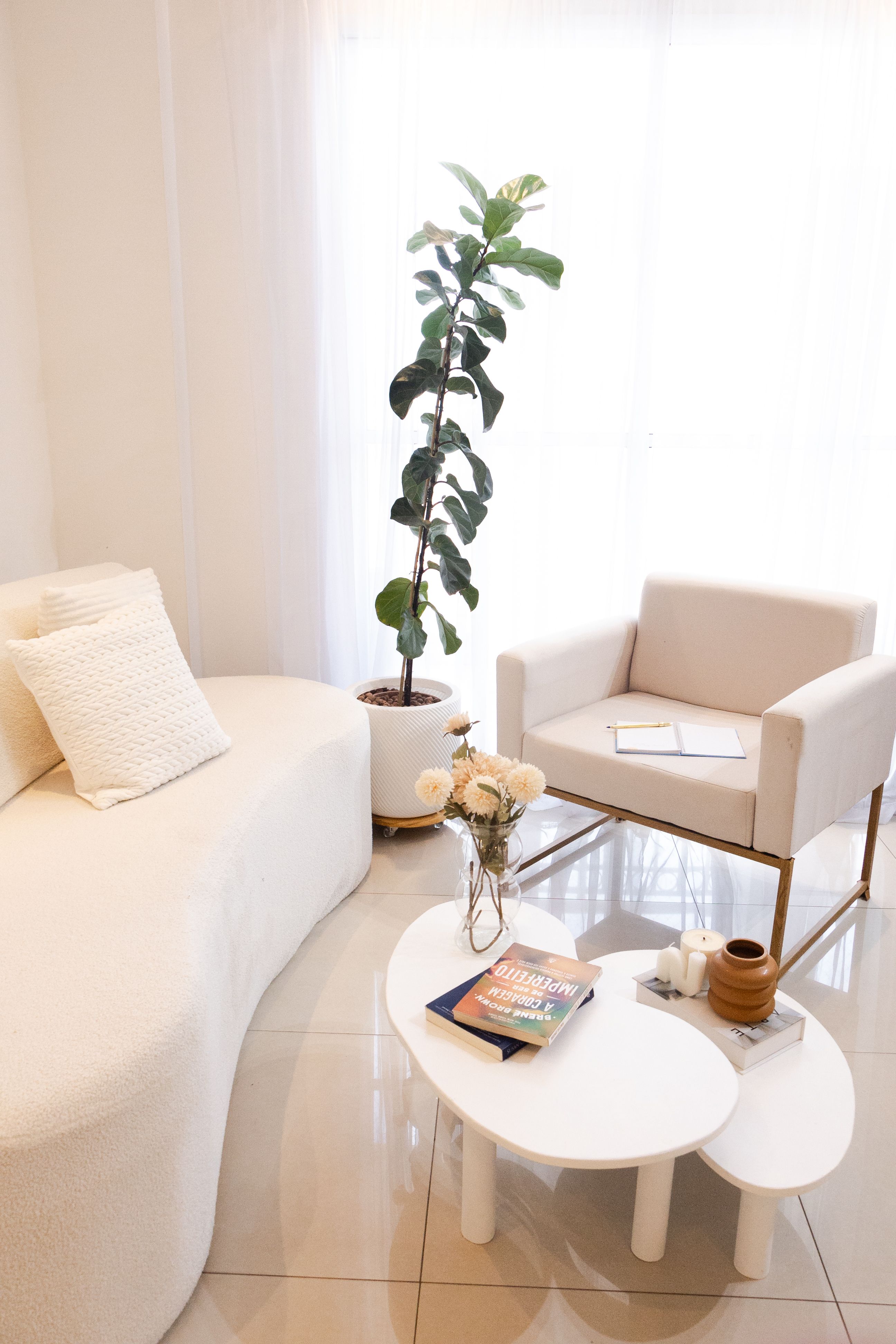 A minimalist living room with freestanding white sofa and modern decor
