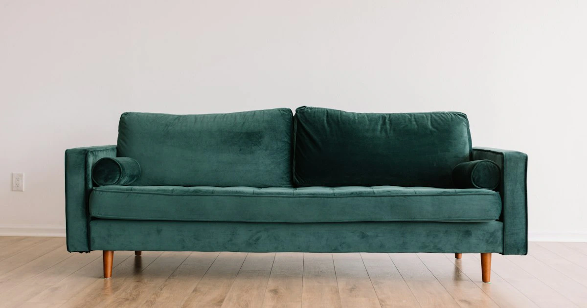 Teal velvet sofa in a bright contemporary apartment interior