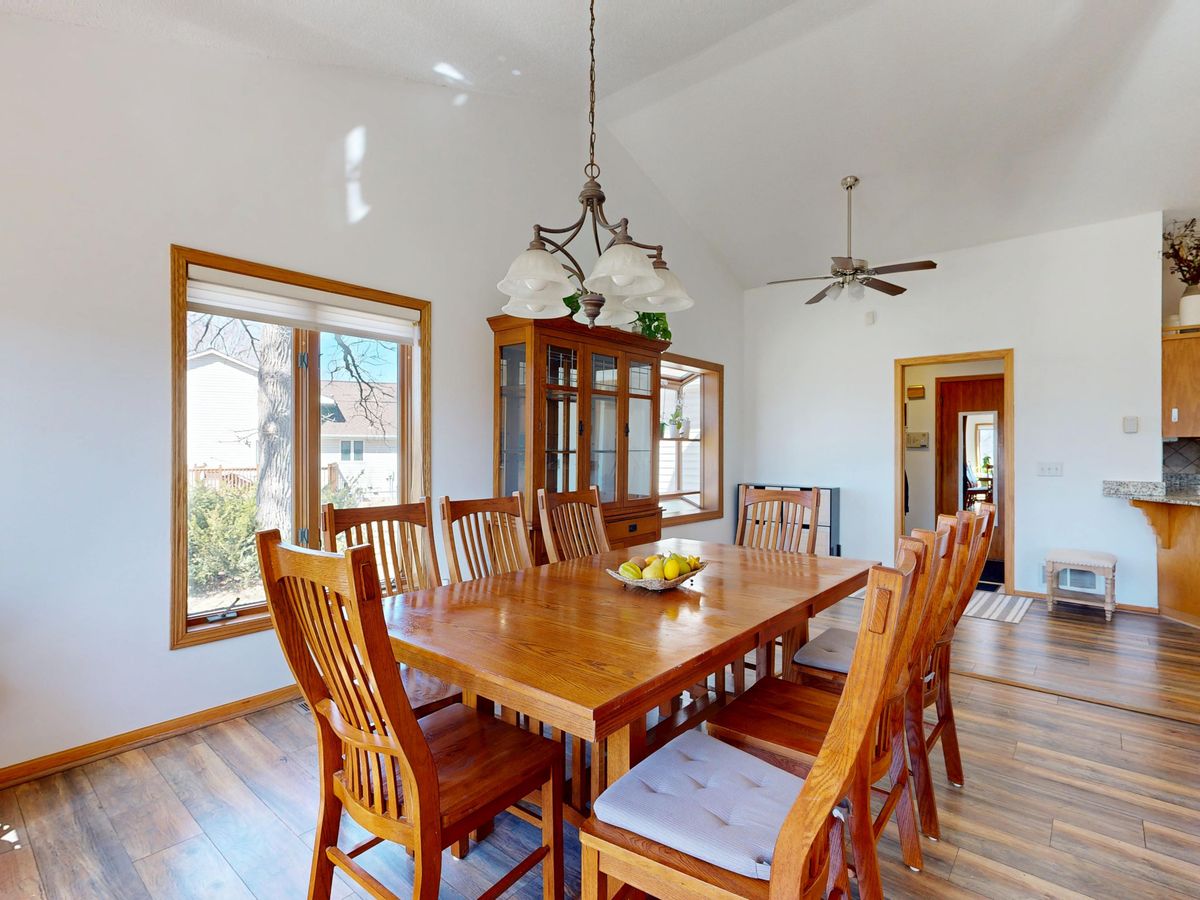 Cozy dining room with a solid wood table and chairs lit by natural window light