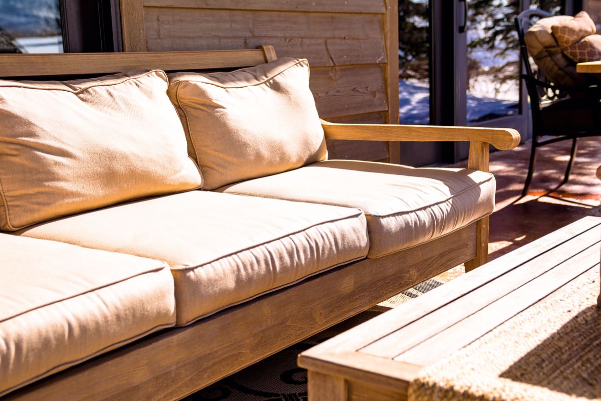 Comfortable outdoor patio seating with cushioned furniture in a cozy modern setting