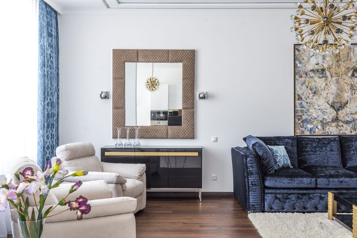 A cozy modern apartment living room with a sofa and warm neutral palette