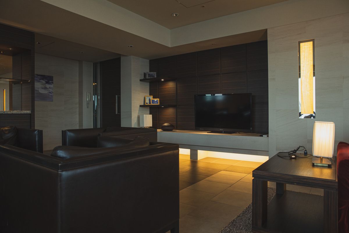 A modern apartment living room with minimal furniture in neutral tones