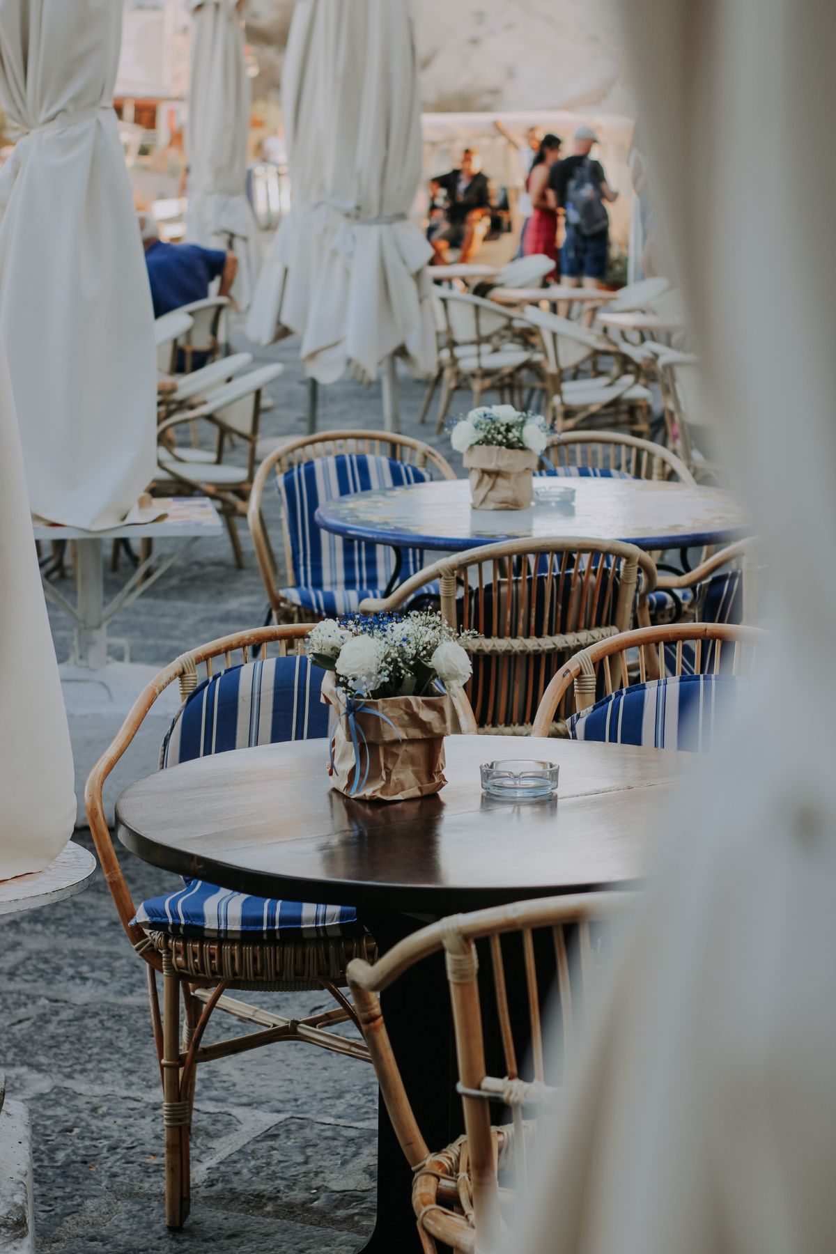 Contemporary outdoor restaurant setting with metal chairs and tables on a modern patio
