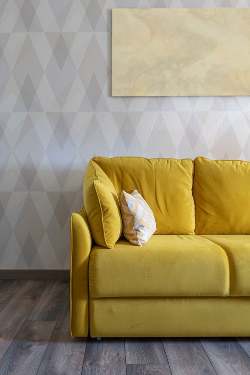 A bright, stylish living room with a modern sofa and warm natural light