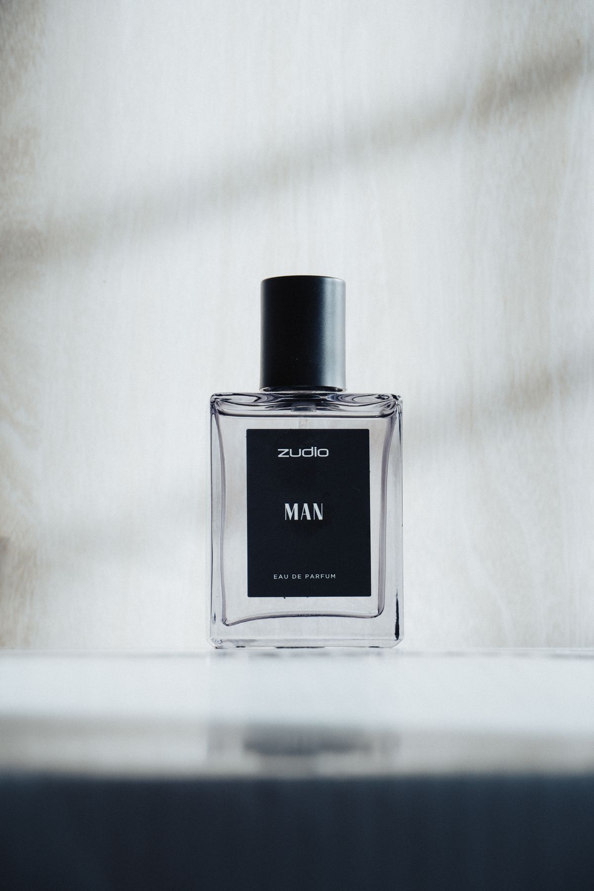 Flacon de parfum élégant au design minimaliste posé sur un fond clair
