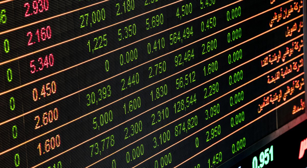 Digital stock ticker numbers displayed on a trading monitor showing market prices