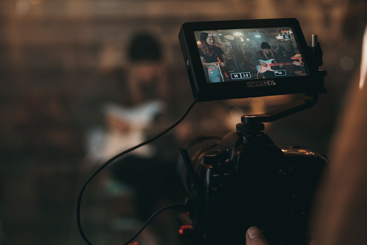 Content creator filming a video with a professional camera