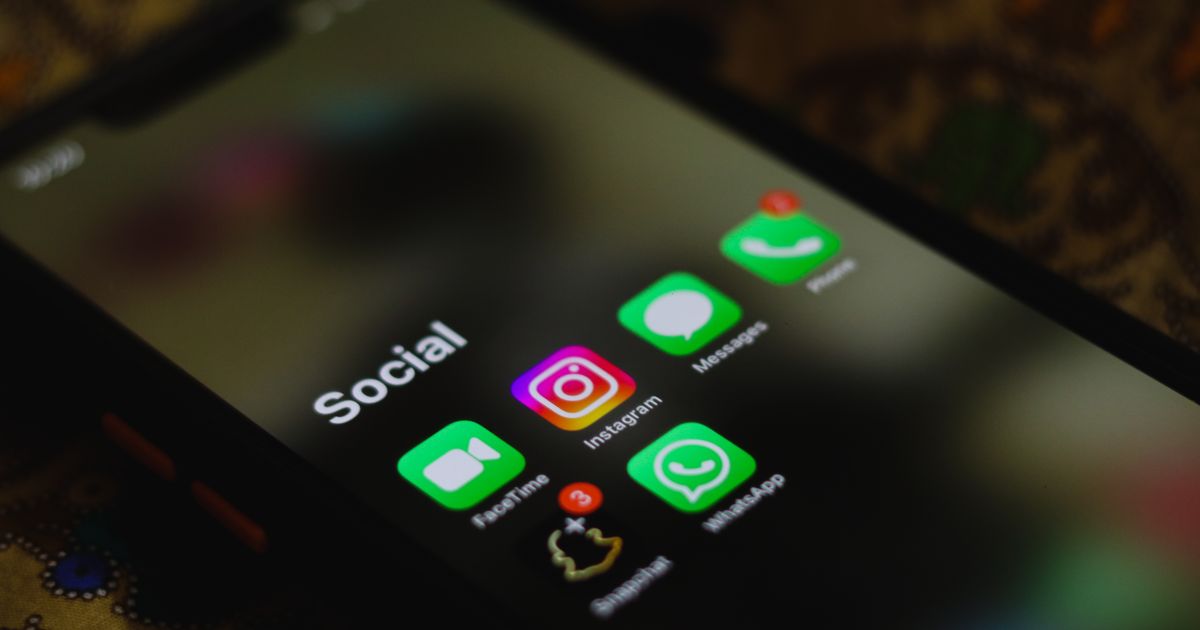 Close-up of a smartphone showing social media app icons