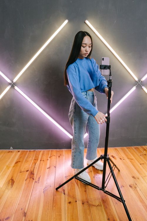Content creator adjusting a camera setup in a home studio for video recording