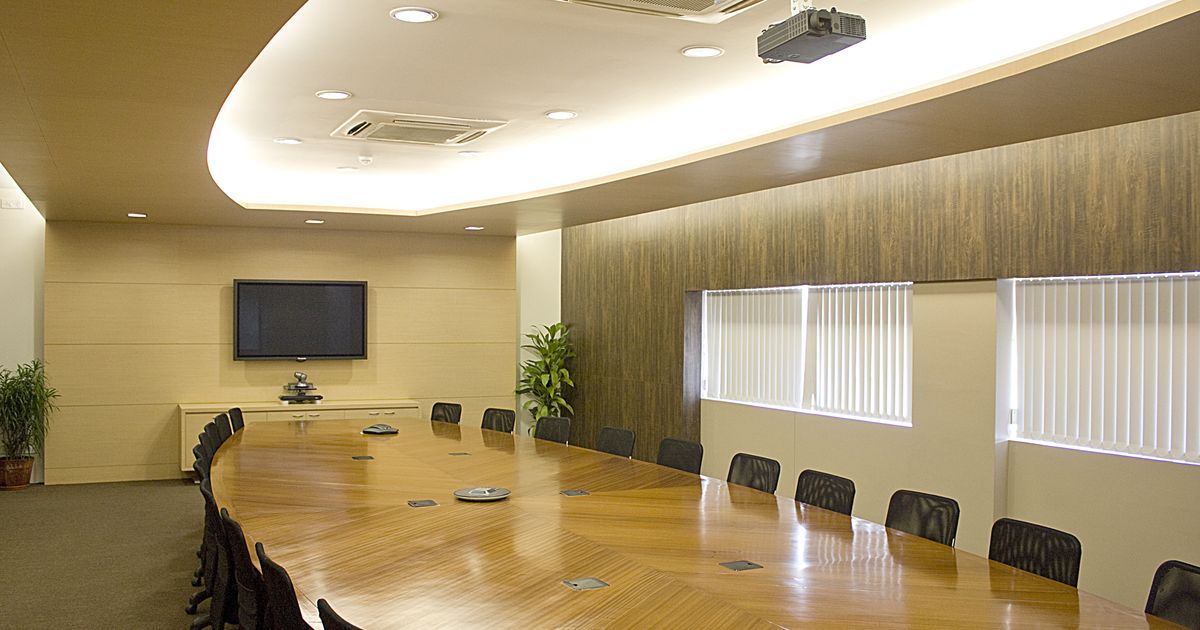 Modern boardroom with executive chairs around a polished conference table