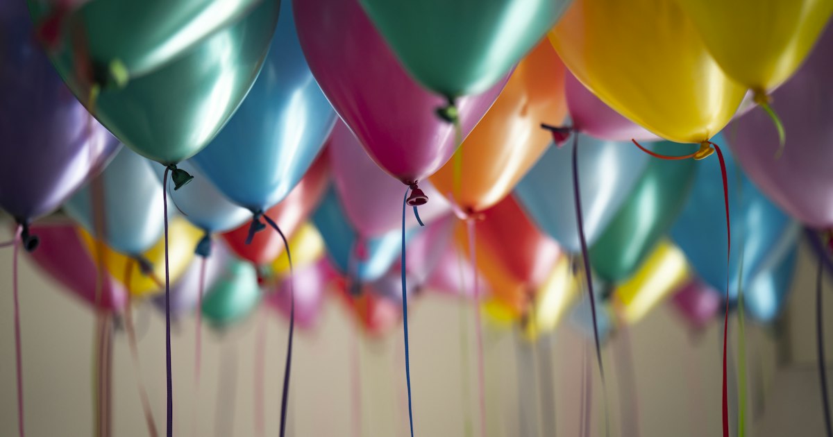 Festive gold and white party balloons and streamers for a celebration
