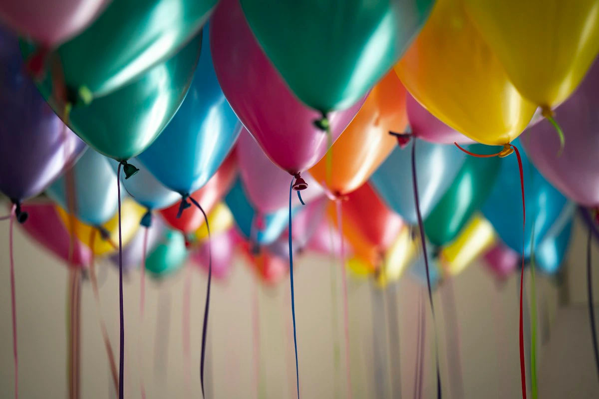 Colorful birthday balloons floating against a bright backdrop, perfect for party planning inspiration.