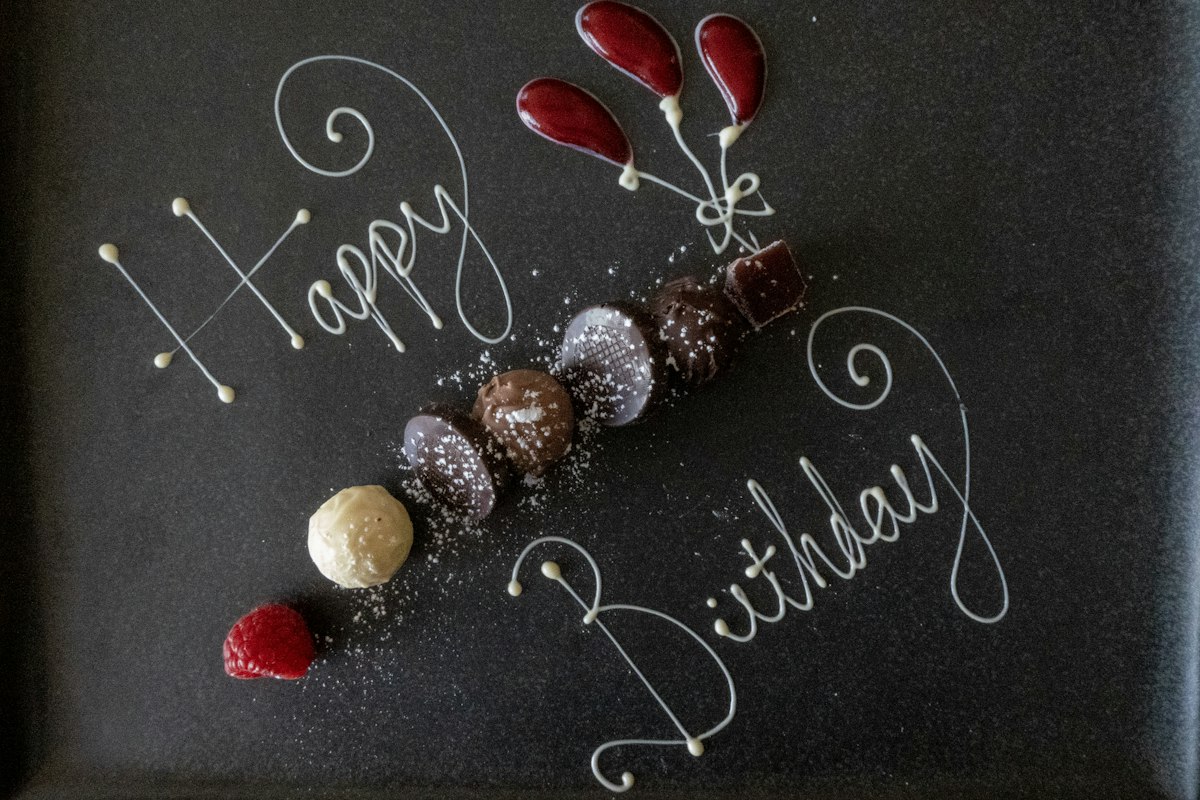 Birthday celebration table with cake, candles, and festive decorations ready for guests.