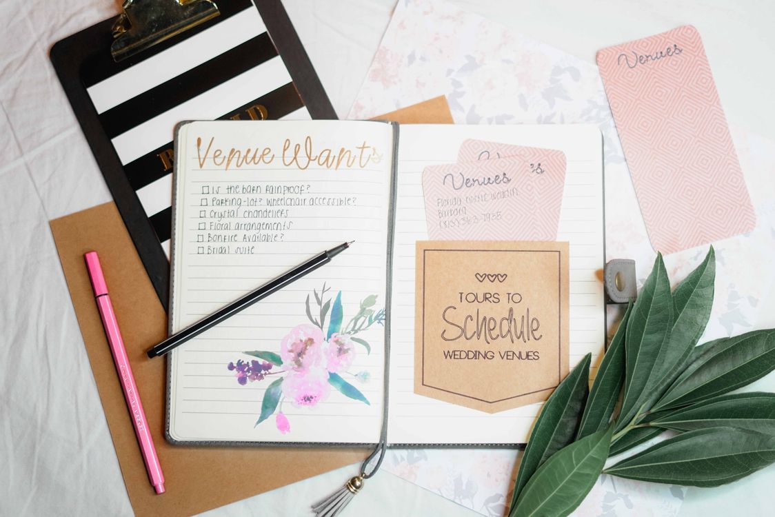 Wedding and event planning materials laid out on a desk