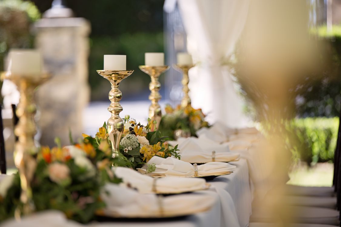 Elegant wedding table setting with candlesticks and floral decorations at an intimate reception