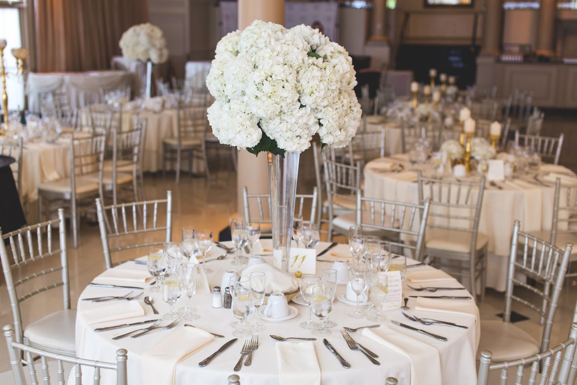Elegantly decorated wedding reception table with floral centerpiece and silverware