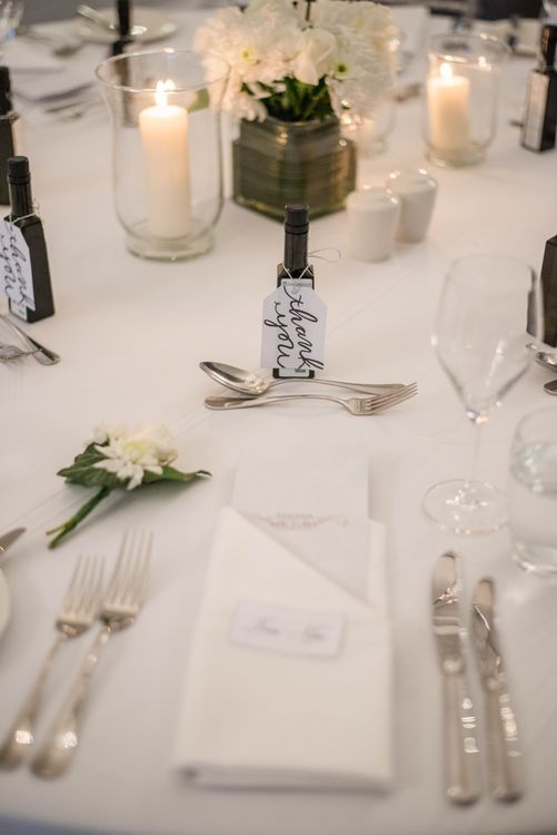 Banquet table with white flowers and candles at a wedding reception