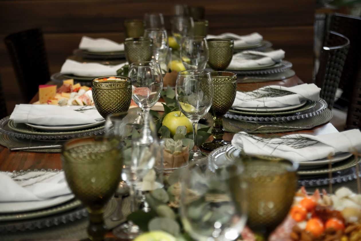 Beautifully arranged dinner table set with green accents for a celebration