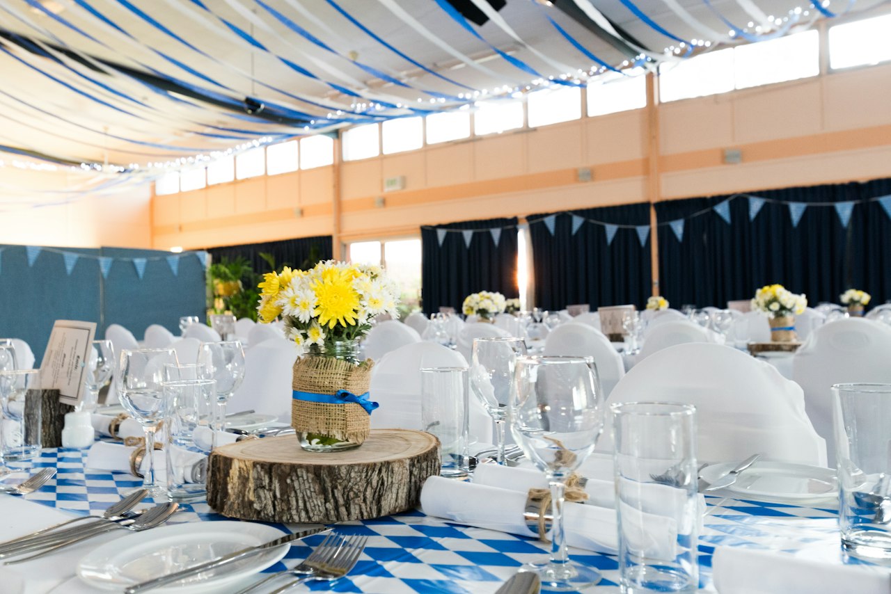 Close-up of a wedding table place setting with napkin, glassware, and a name card